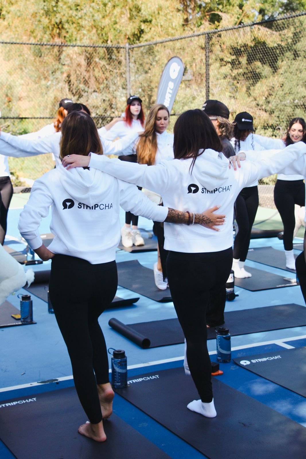 Goat yoga session on the pickleball court at the SC House Hollywood, goats climbing on cast members' backs