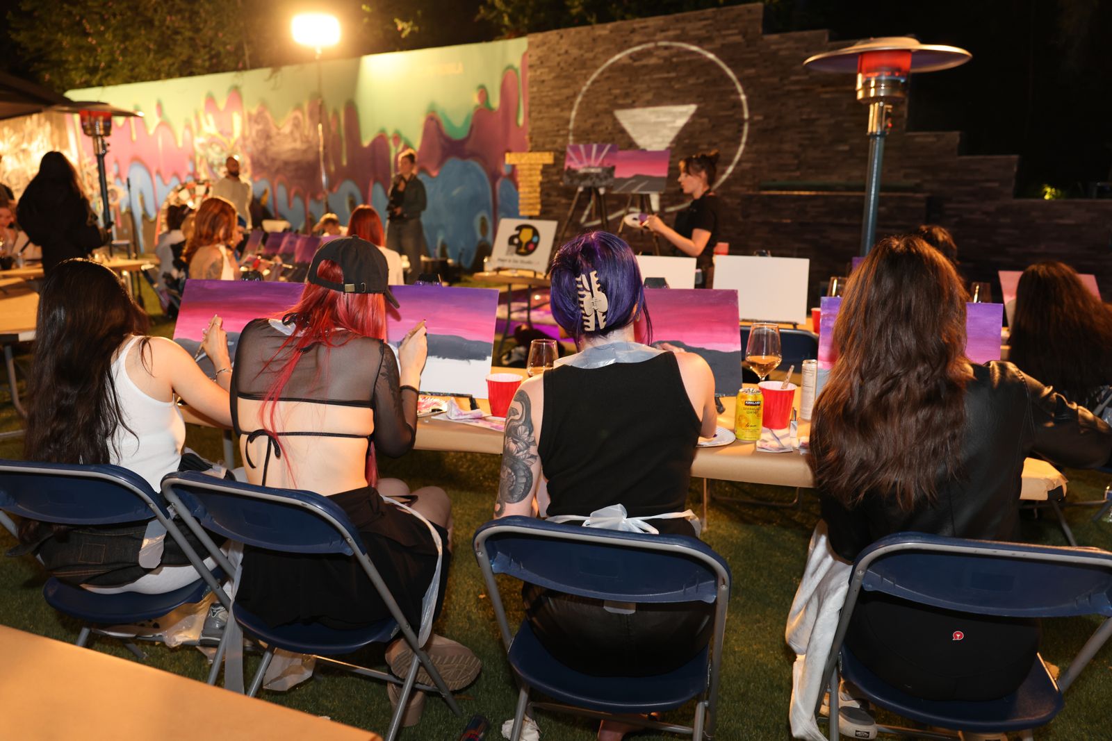 Cast members painting canvases at the evening sip and paint session at the SC House