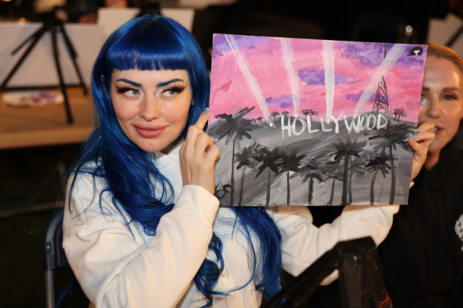 Cast members show off their finished Hollywood paintings at the SC House sip and paint night