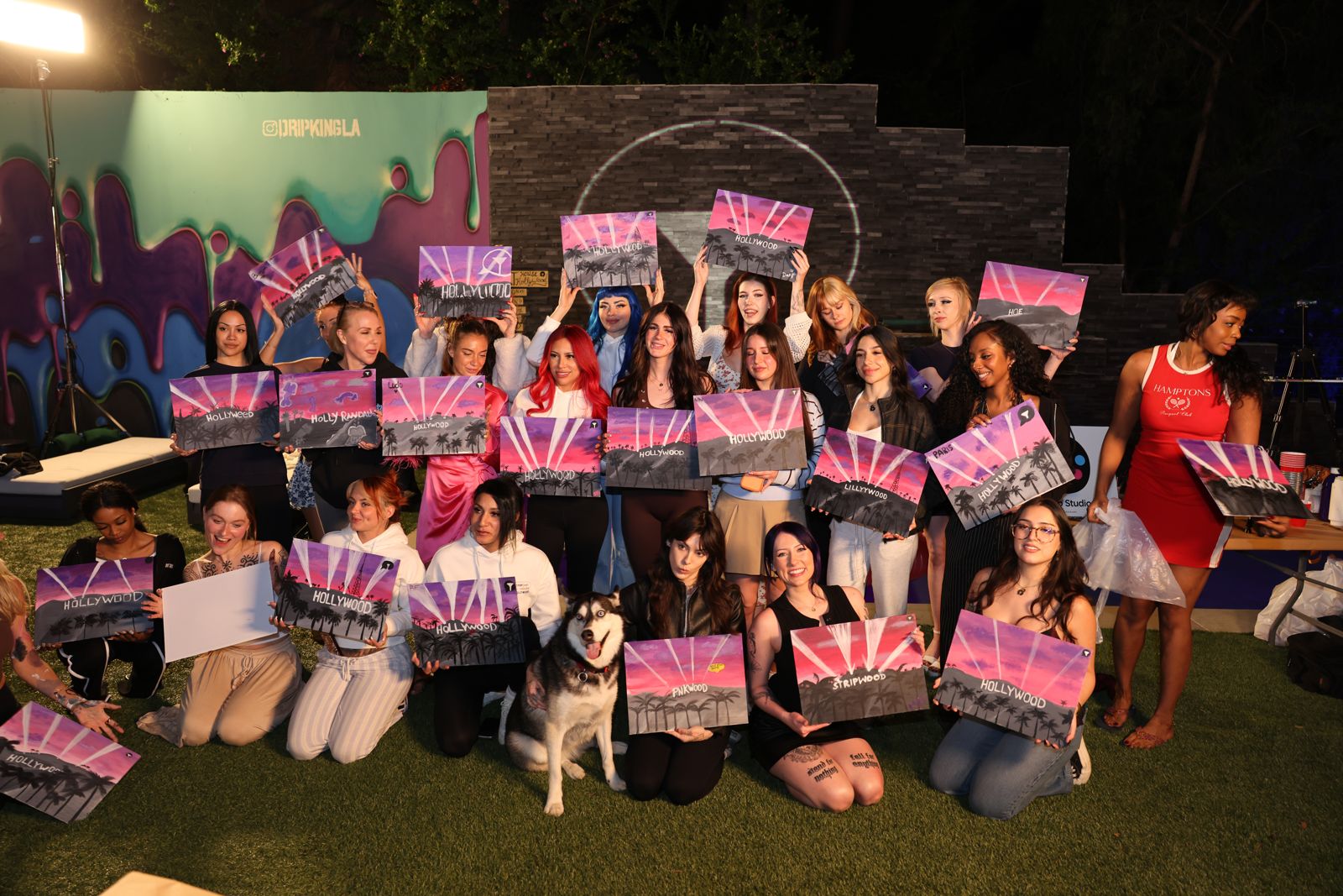 The whole cast holds up their finished Hollywood paintings at the SC House sip and paint
