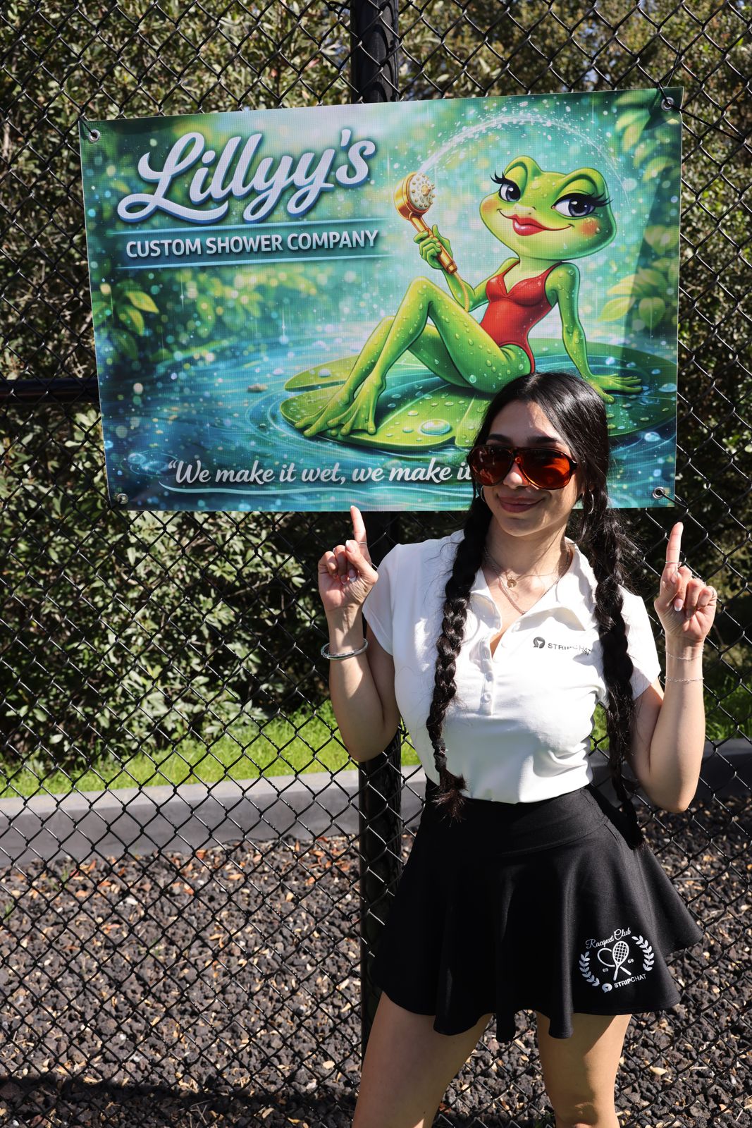 A cast member poses with her parody sponsor banner at the SC House pickleball tournament