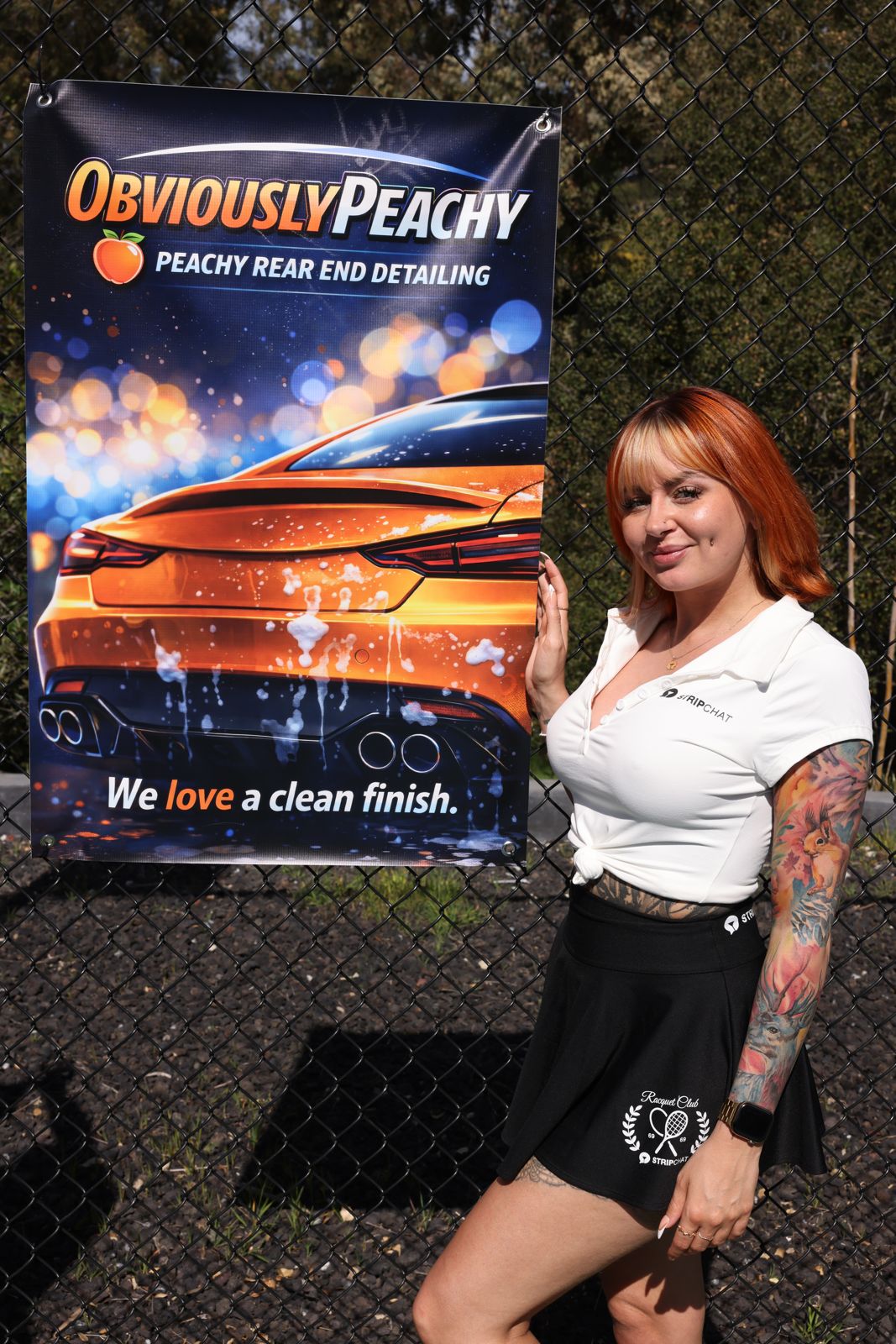 A cast member poses with her parody sponsor banner at the SC House pickleball tournament